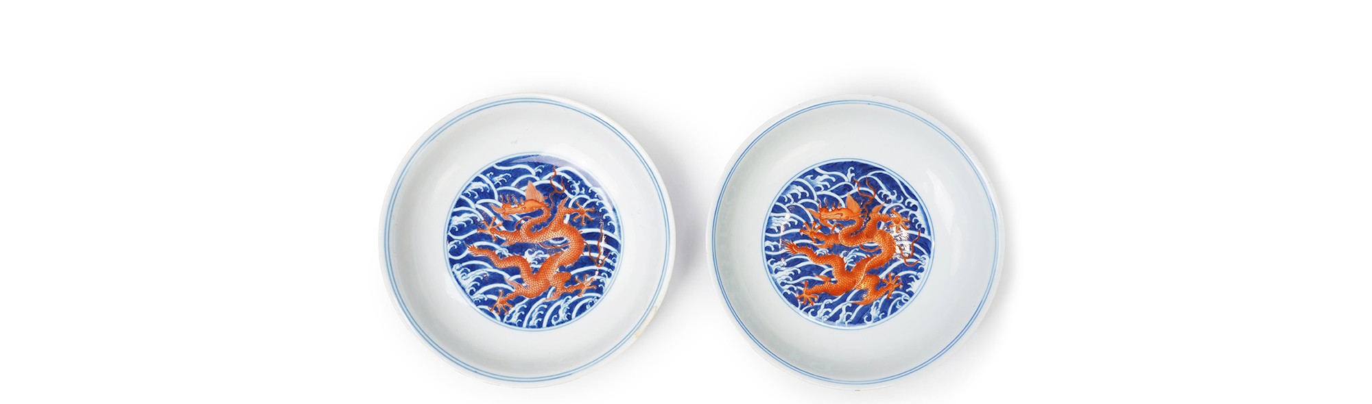 A pair of Chinese iron red and underglaze blue ‘dragon’ dishes, Qianlong seal mark and of the period (1736-95) A pair of Chinese iron red and underglaze blue ‘dragon’ dishes, Qianlong seal mark and of the period (1736-95)