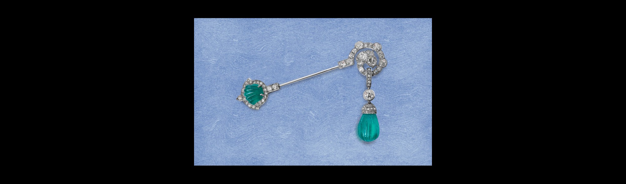 A fine Art Deco carved emerald and diamond jabot pin, circa 1925