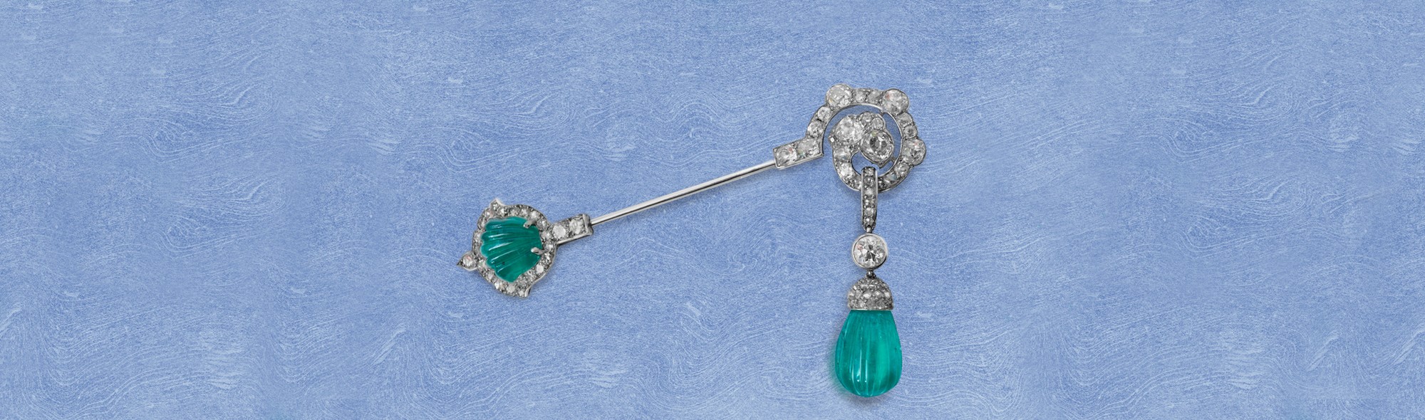 A fine Art Deco carved emerald and diamond jabot pin, circa 1925