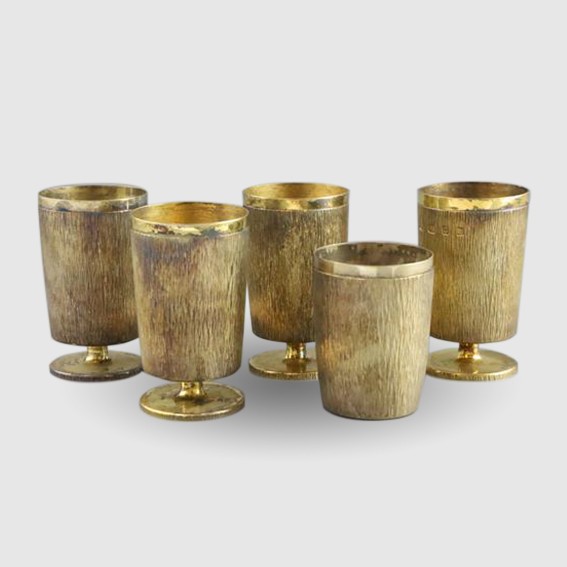 set of four bark effect silver gilt goblets