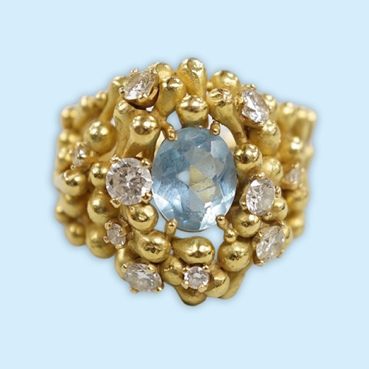 An early 1970's modernist 18ct gold, aquamarine and diamond cluster set dress ring