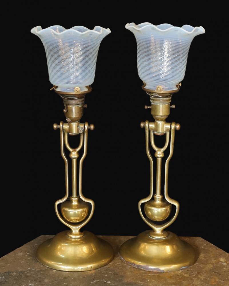 A pair of brass Pullman lamps with gimbal stems and Vaseline glass shades