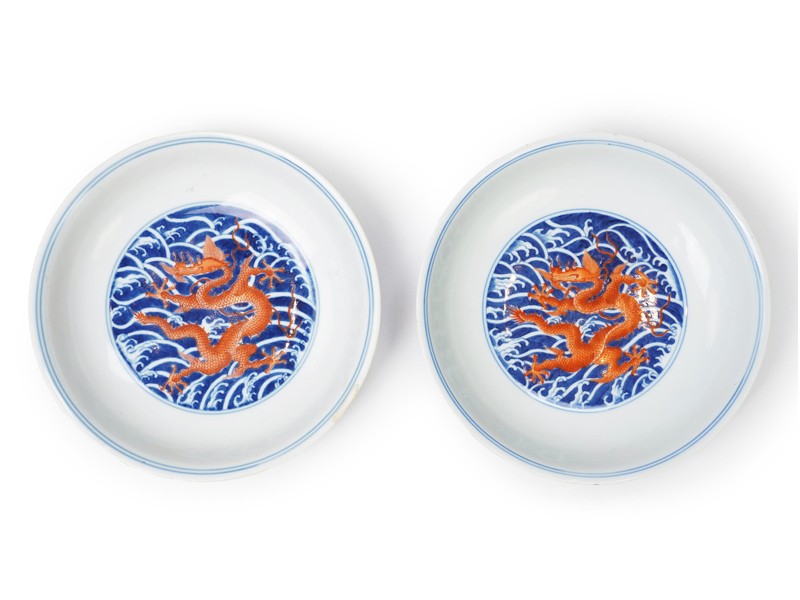 A pair of Chinese iron red and underglaze blue ‘dragon’ dishes, Qianlong seal mark and of the period (1736-95) A pair of Chinese iron red and underglaze blue ‘dragon’ dishes, Qianlong seal mark and of the period (1736-95)