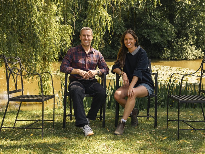 Oliver Searle and Imogen Perreau seated on metal chairs in a garden Oliver Searle and Imogen Perreau seated on metal chairs in a garden