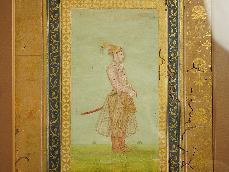 Mogul (Mughal) School , Profile Portrait of a Mogul dignitary, possibly Shah Jahan (1592-1666), full length, wearing court attire and a sword, standing in a landscape, watercolour miniature Mogul (Mughal) School , Profile Portrait of a Mogul dignitary, possibly Shah Jahan (1592-1666), full length, wearing court attire and a sword, standing in a landscape, watercolour miniature